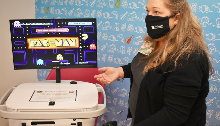 A nurse named Lisa playing Pac-man on her GoKart mobile workstation.