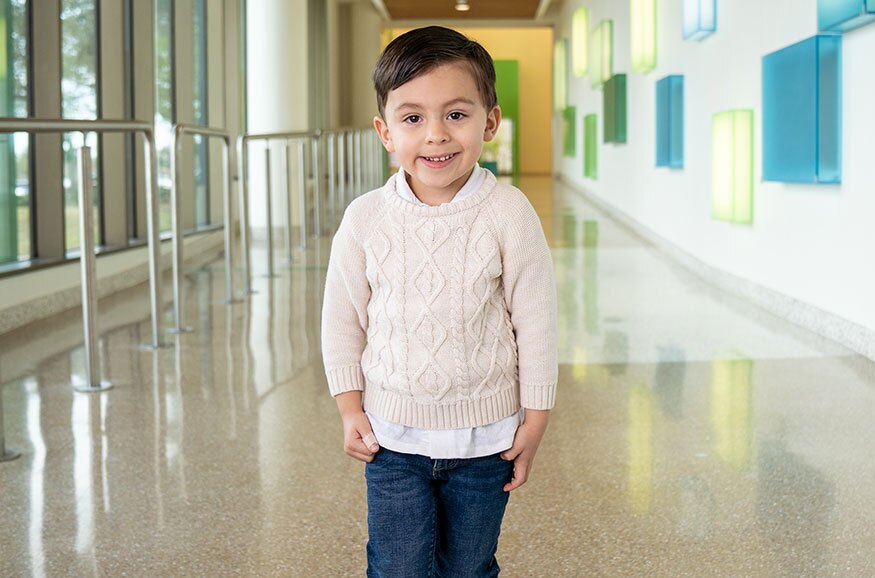 Preston Simpson standing in the hall at Driscoll Children's hospital.