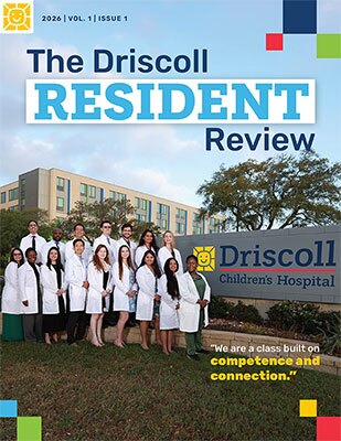 Cover of The Driscoll Resident Review showing a group of residents in white coats outside Driscoll Children’s Hospital.