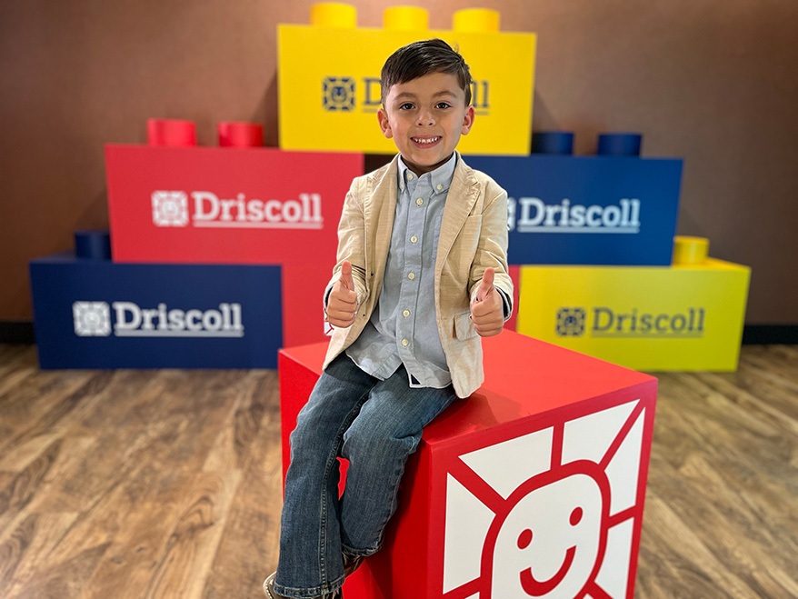 Preston Simpson smiling with thumbs up at Driscoll Children's hospital.