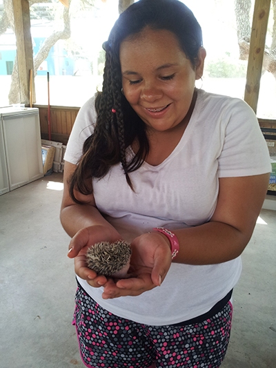 girl holding small animal