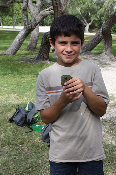 boy holding fish at camp