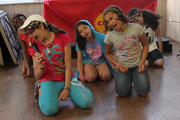 girls at camp singing