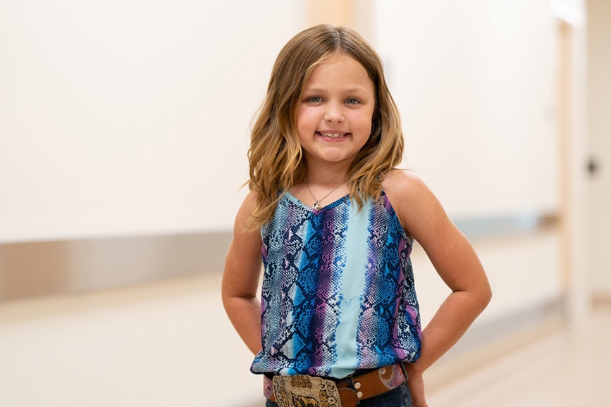 Happy girl standing in the hospital hallway.