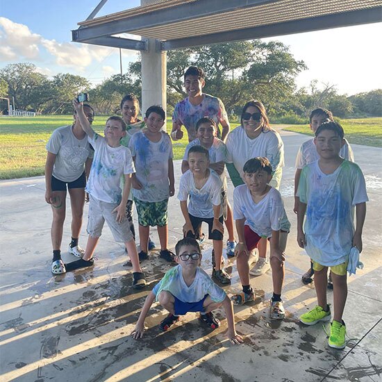 Group of happy children with wet shirts from water games.