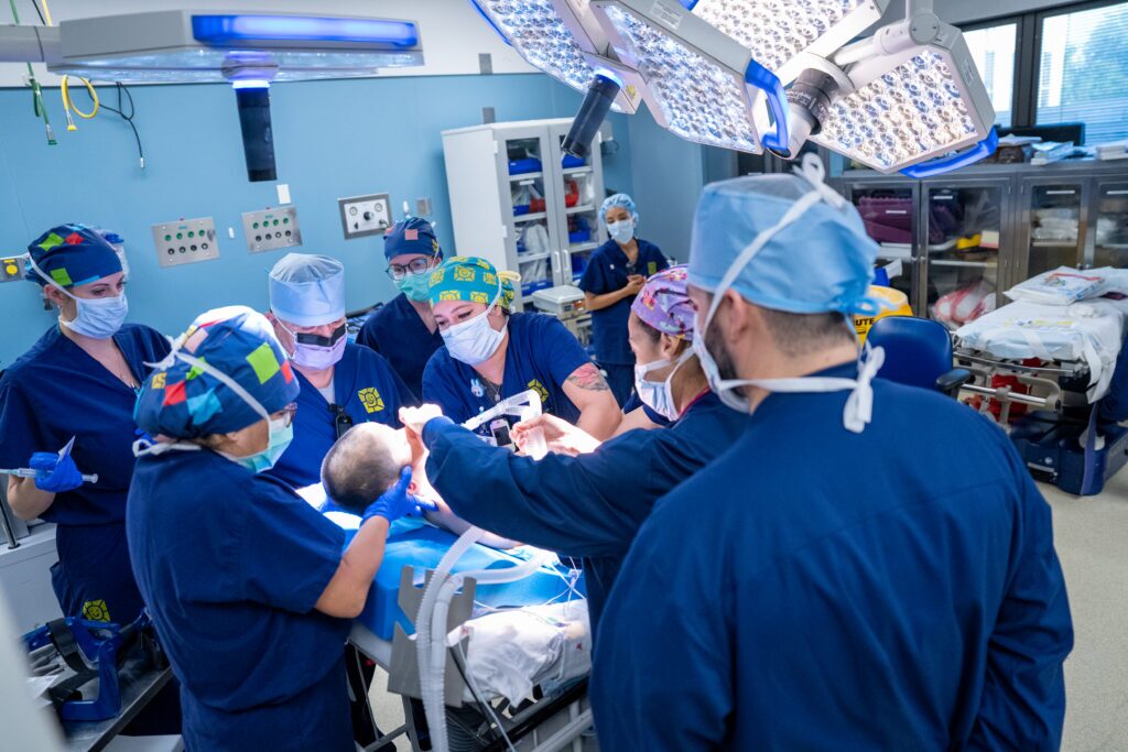 neurosurgeons and clinical staff prepare boy for surgery.